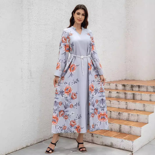 Middle Eastern and Turkish fashionable printed Muslim women's abaya with a waistband. It is a casual V-neck dress from Dubai.